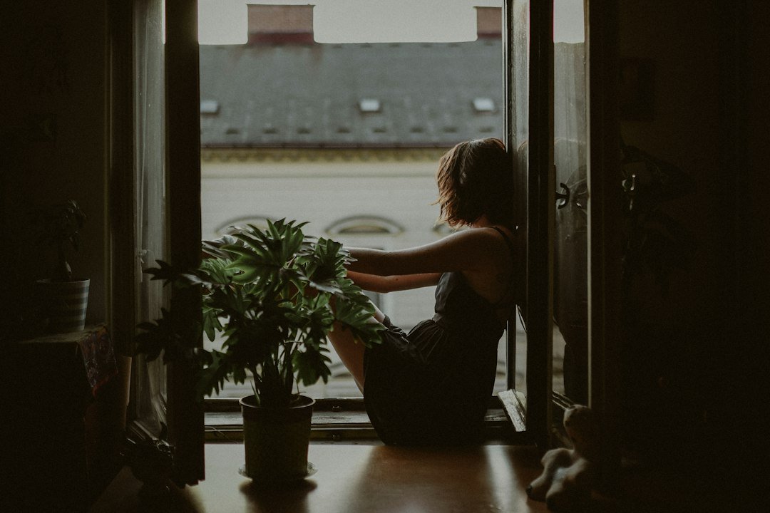 Woman by a doorway in natural light, representing Esther in the Bible, courage and purpose
