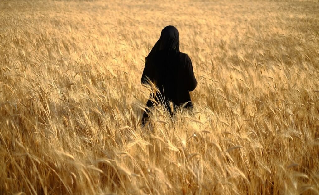 Woman standing in a wheat field, representing Ruth in the Bible and starting over with God